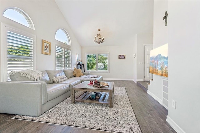 living area with baseboards, high vaulted ceiling, dark wood-style flooring, and a notable chandelier