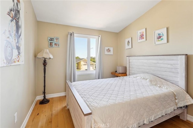 bedroom featuring hardwood / wood-style floors and baseboards