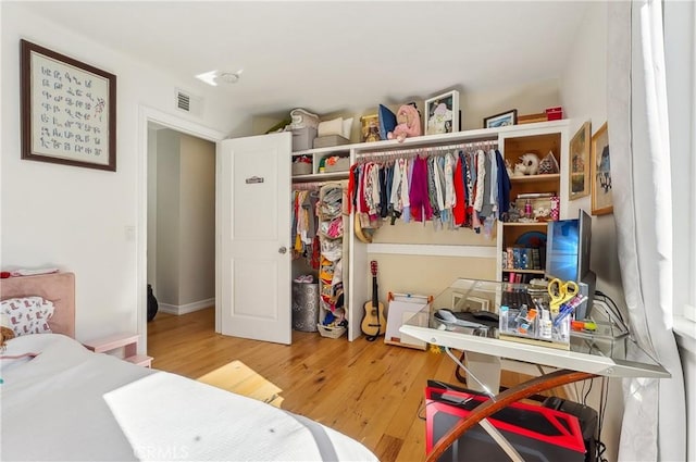 bedroom with wood finished floors and visible vents