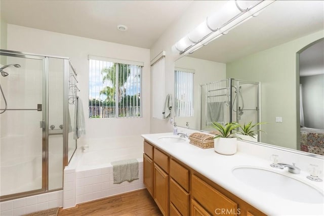 bathroom with a garden tub, a sink, and a shower stall