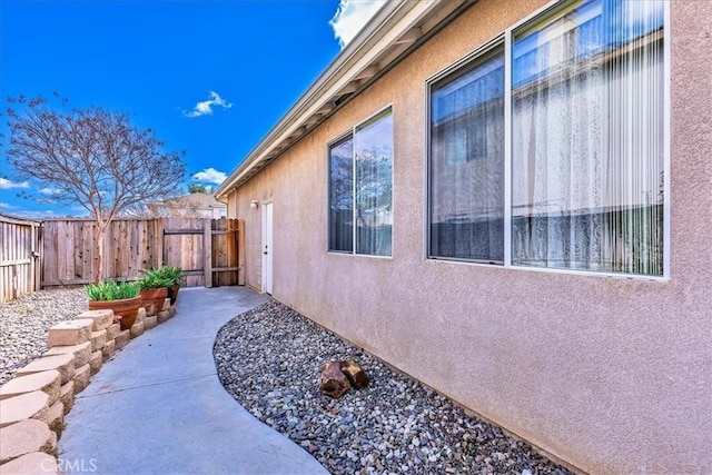 view of home's exterior featuring fence and stucco siding