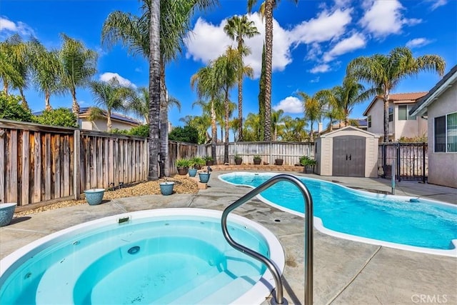 view of pool with a fenced in pool, a fenced backyard, an in ground hot tub, a storage unit, and an outdoor structure