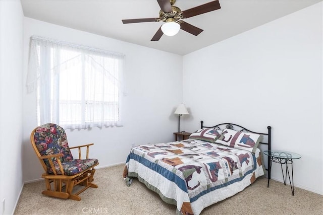 carpeted bedroom with baseboards and a ceiling fan