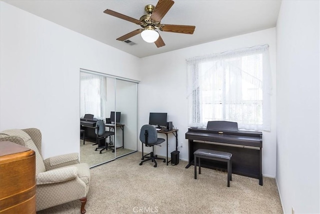 carpeted home office featuring a ceiling fan and visible vents