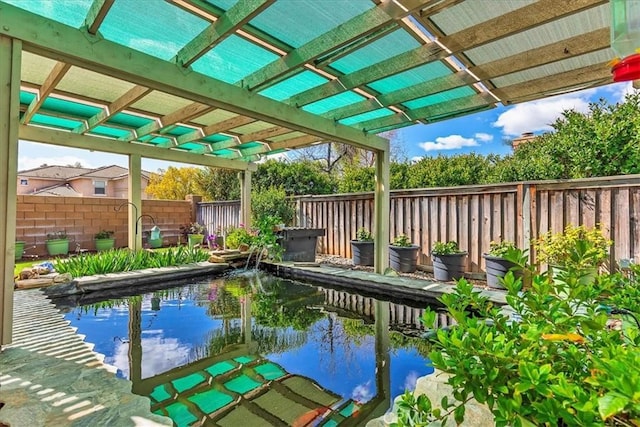 view of swimming pool with a fenced backyard and a pergola