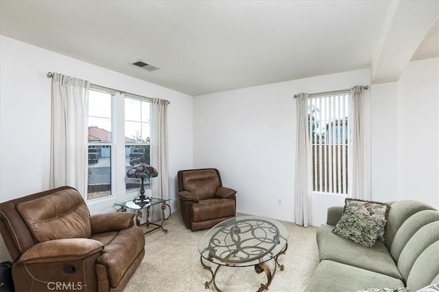 living room featuring light carpet and visible vents