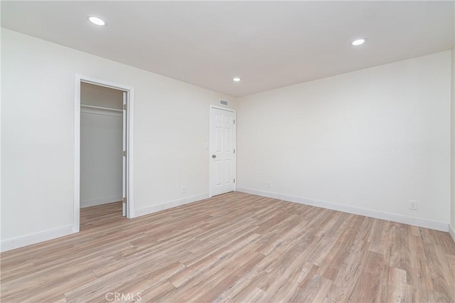 unfurnished bedroom with recessed lighting, light wood-type flooring, visible vents, and baseboards