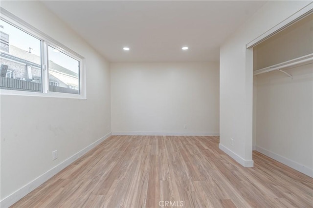 unfurnished bedroom with light wood-style floors, recessed lighting, a closet, and baseboards