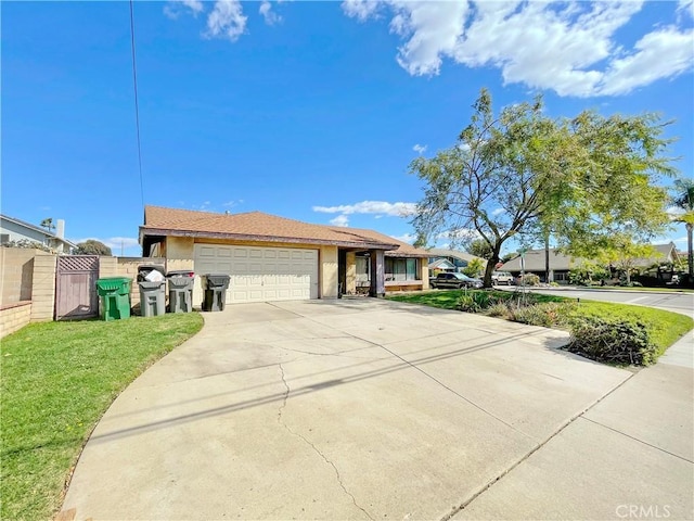 single story home featuring stucco siding, concrete driveway, a gate, a garage, and a front lawn