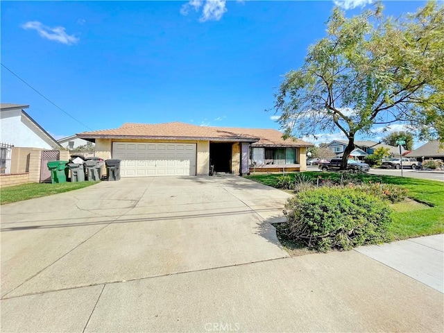 ranch-style home with concrete driveway, an attached garage, and stucco siding