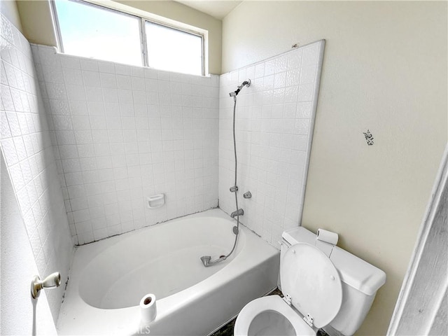 bathroom featuring shower / bath combination and toilet