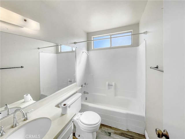 full bath with  shower combination, vanity, wood finished floors, and toilet