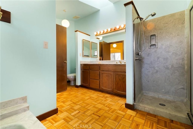 full bathroom with a walk in shower, a sink, double vanity, toilet, and baseboards