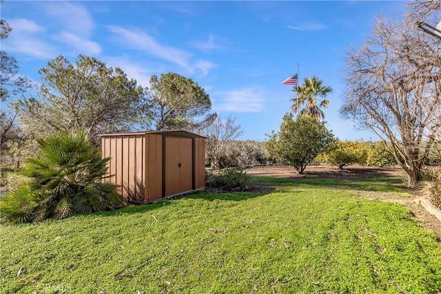 view of yard featuring a storage shed and an outdoor structure