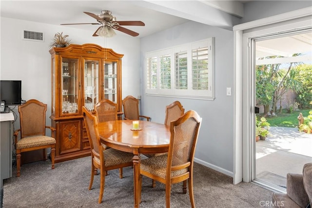 dining area with a wealth of natural light, light colored carpet, and visible vents