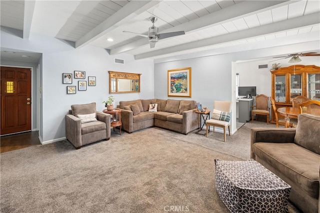 carpeted living area featuring visible vents, beam ceiling, baseboards, and a ceiling fan