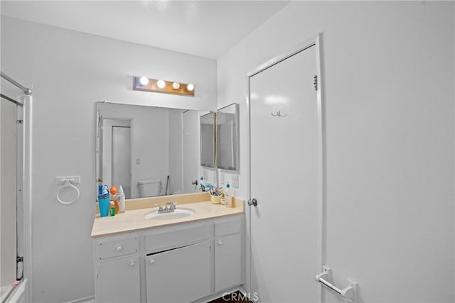 full bathroom with toilet, a shower, and vanity