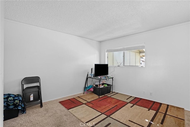 rec room featuring a textured ceiling and carpet flooring