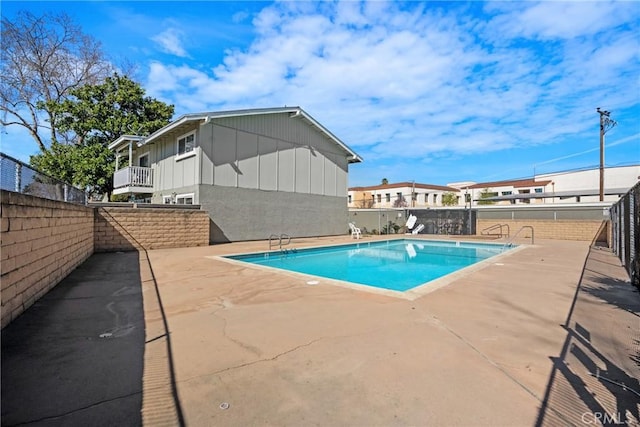 view of swimming pool with a patio area, fence, and a fenced in pool