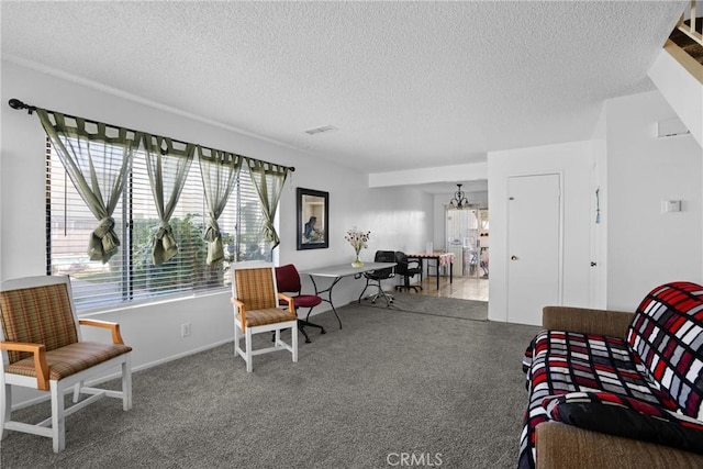 living area with carpet floors, visible vents, a notable chandelier, and a textured ceiling