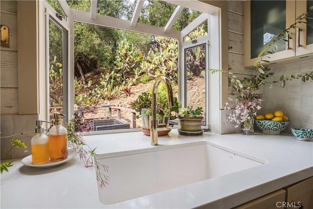 doorway featuring a skylight and a sink