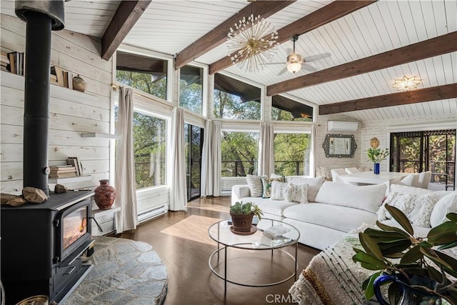 sunroom featuring vaulted ceiling with beams, a wall mounted AC, a wood stove, and a ceiling fan