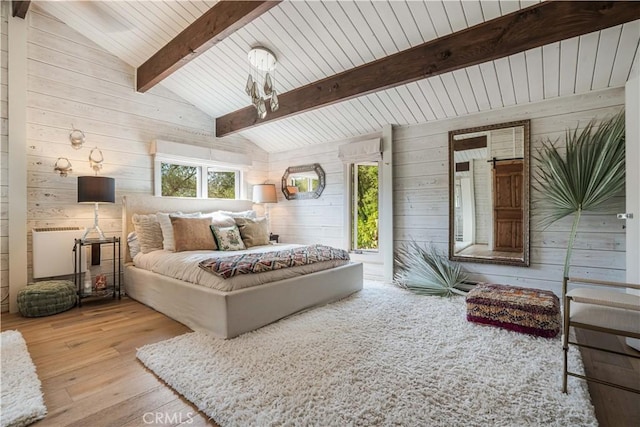 bedroom with vaulted ceiling with beams, wood-type flooring, and wooden walls