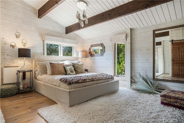 bedroom featuring vaulted ceiling with beams, wood walls, and wood finished floors