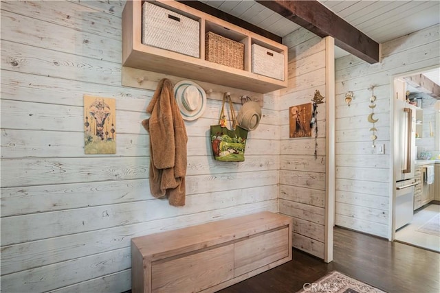 mudroom with wood walls, wood ceiling, dark wood-style floors, and beamed ceiling