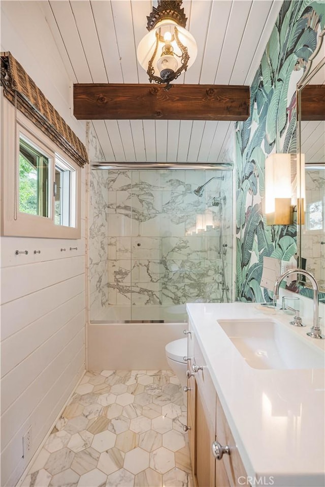 full bath with wooden ceiling, toilet, bath / shower combo with glass door, vanity, and beamed ceiling