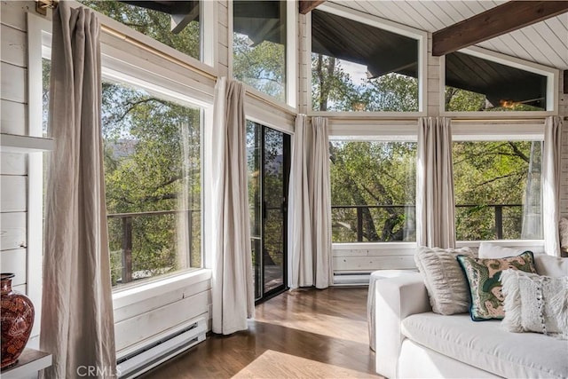 sunroom / solarium featuring a baseboard heating unit and lofted ceiling with beams