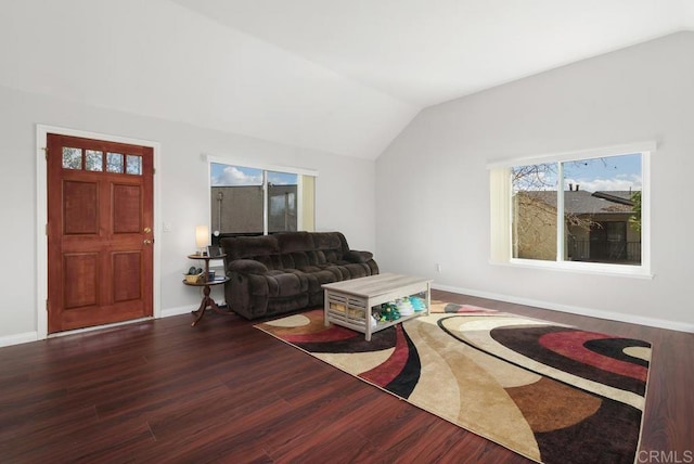 living area with lofted ceiling, baseboards, and wood finished floors