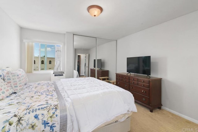 bedroom with a closet, baseboards, and carpet flooring