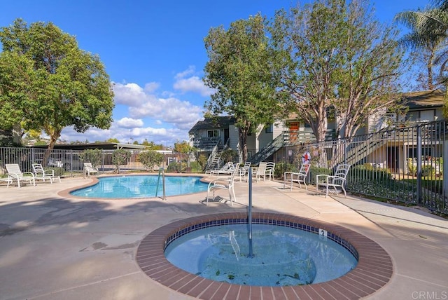 pool featuring a patio area and fence