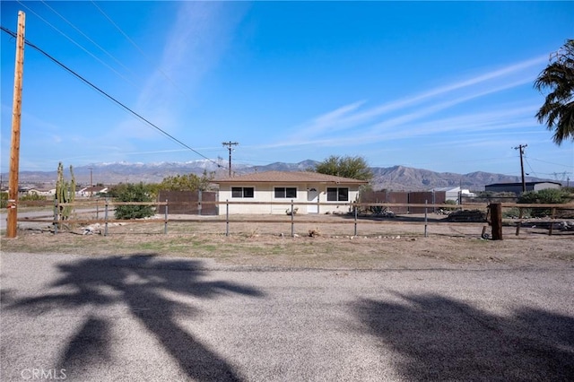 view of yard featuring fence and a mountain view