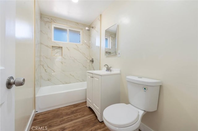 full bath featuring baseboards, toilet, wood finished floors, bathtub / shower combination, and vanity