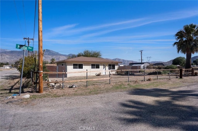 exterior space with a mountain view and fence