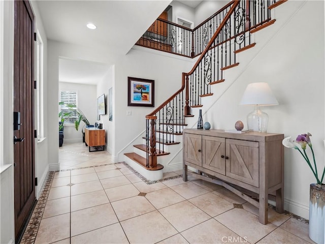 entryway featuring recessed lighting, stairway, baseboards, and light tile patterned floors