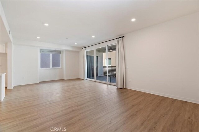 unfurnished room featuring recessed lighting, baseboards, and light wood finished floors