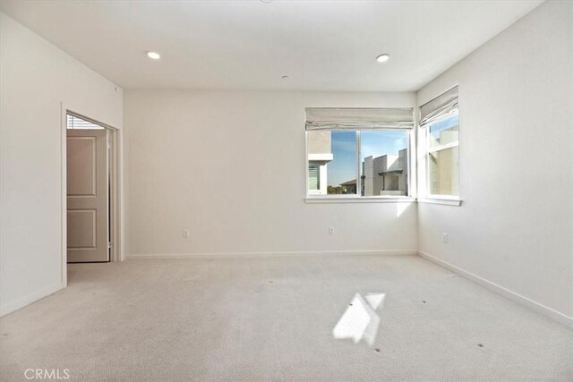 unfurnished room with carpet floors, baseboards, and recessed lighting