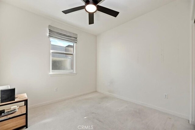 unfurnished room featuring a ceiling fan, carpet, and baseboards