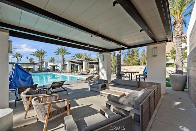 view of patio with a community pool and an outdoor hangout area