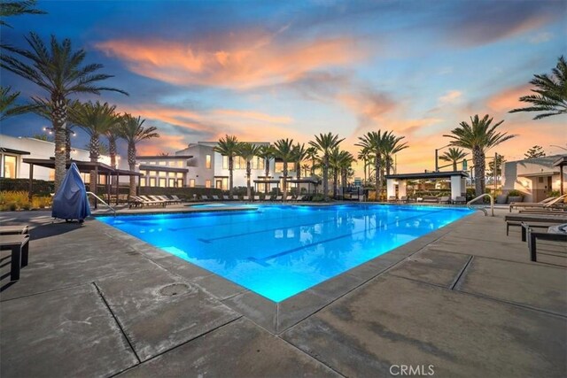 community pool with a patio and a jacuzzi