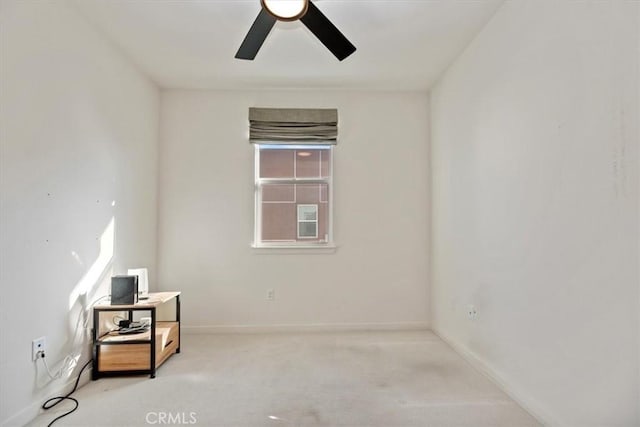 spare room with ceiling fan, carpet flooring, and baseboards