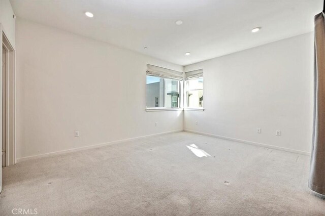 unfurnished room with carpet floors, recessed lighting, and baseboards