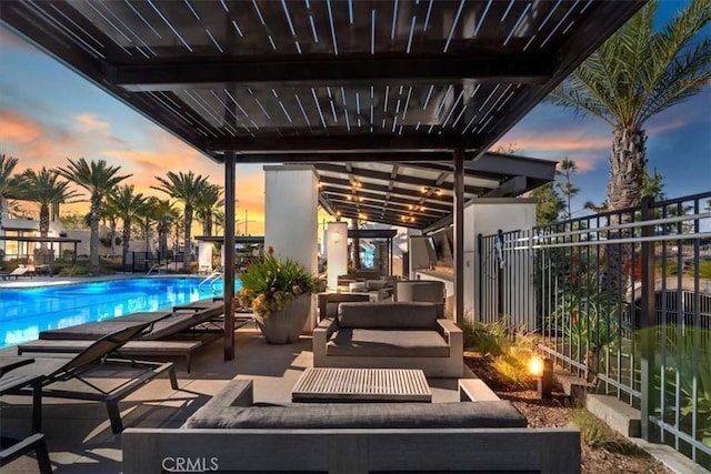 view of patio featuring a community pool and fence