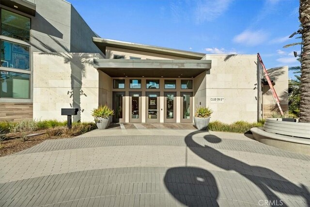 view of exterior entry with stucco siding