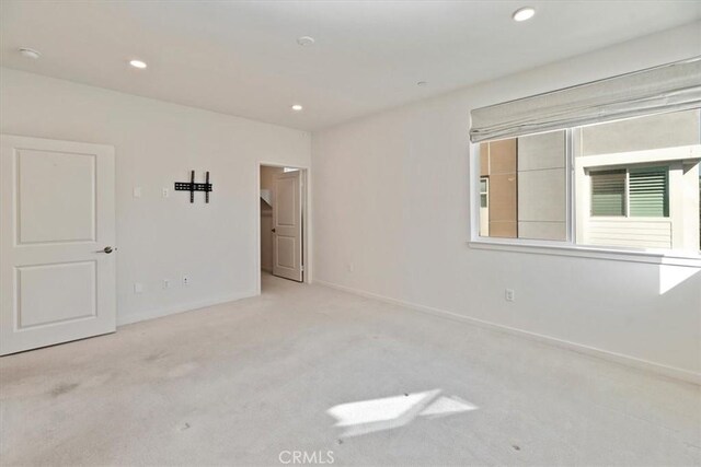 spare room with baseboards, carpet, and recessed lighting