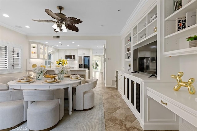 dining space with visible vents, built in shelves, a ceiling fan, crown molding, and recessed lighting