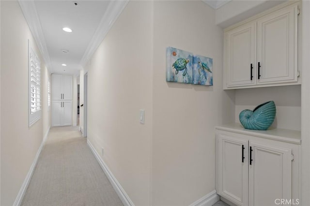 hall featuring light carpet, recessed lighting, baseboards, and crown molding